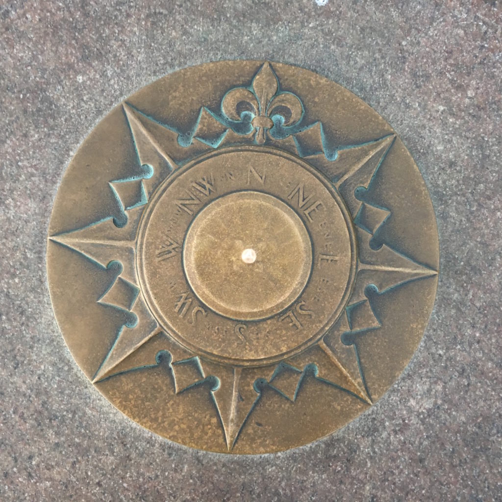 Bronze compass on top of the Zero Milestone