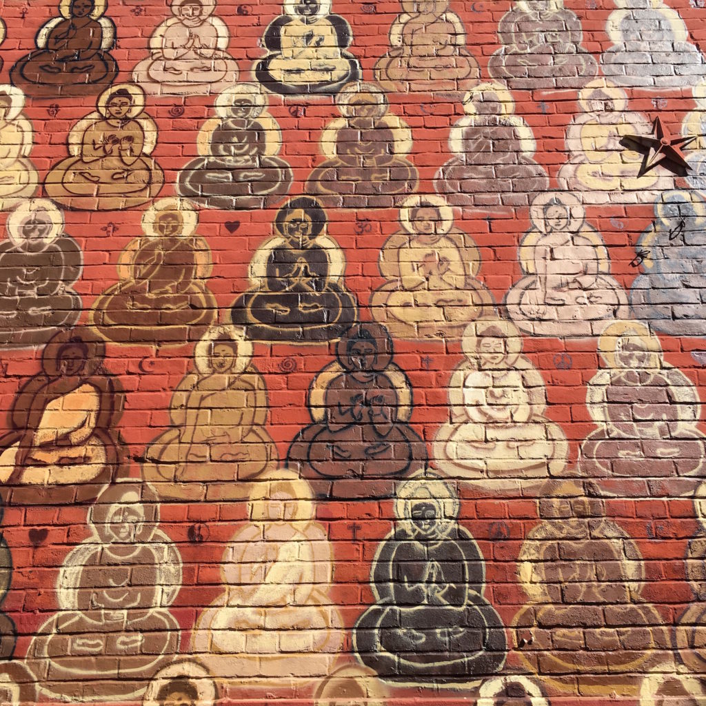 Buddhas Mural - close up of Buddhas on bricks